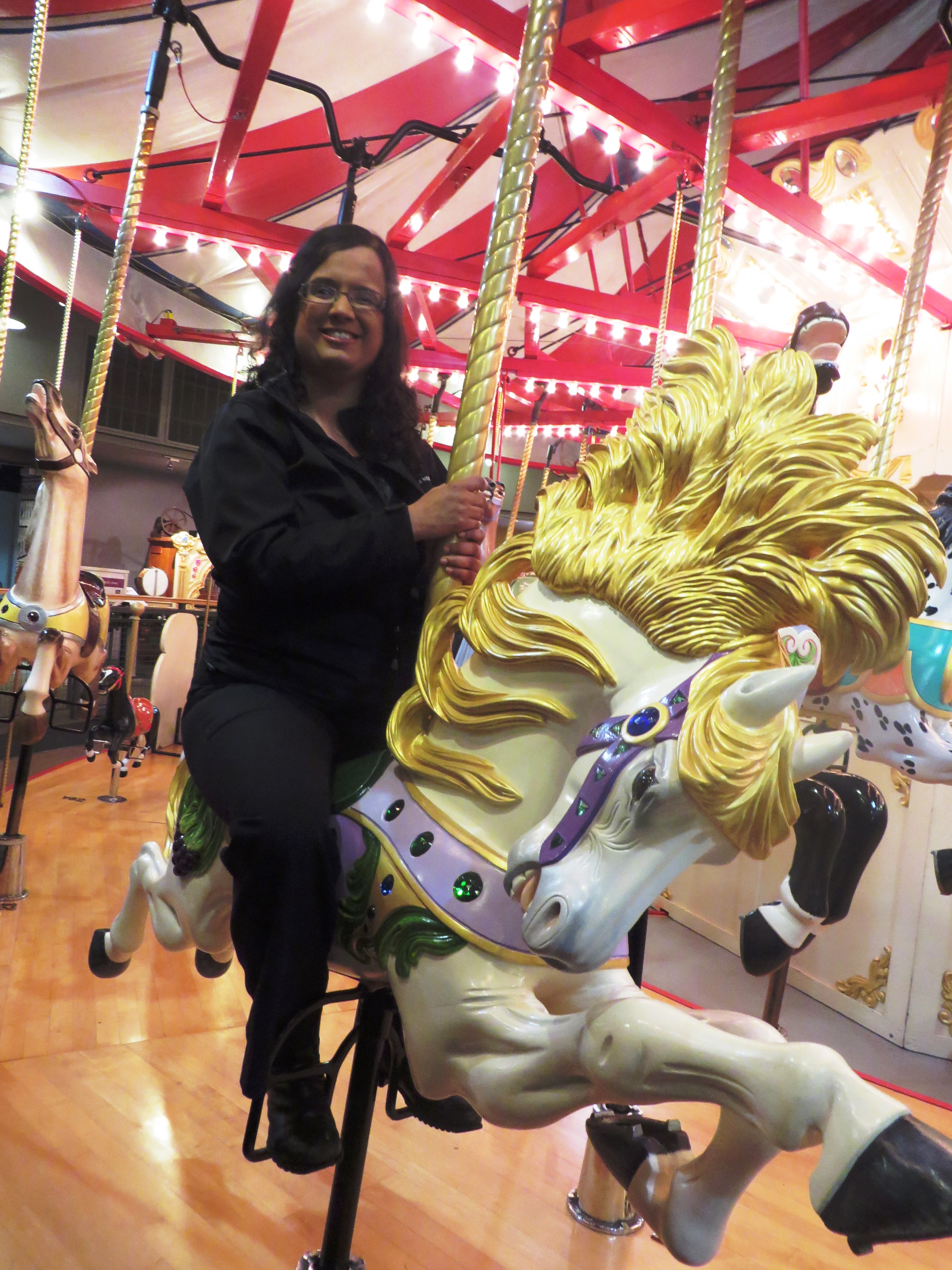 Kristy rides the C W Parker Carousel