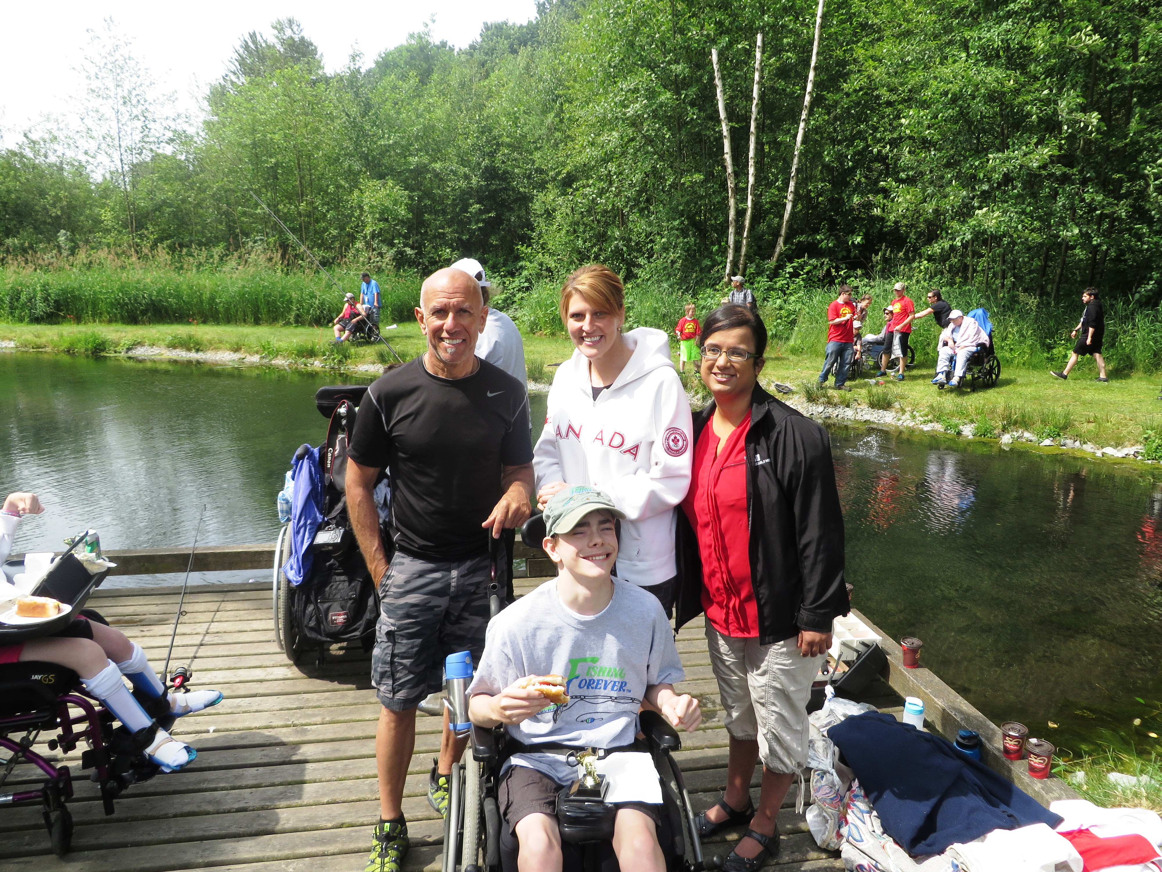 Kristy with Fishing Forever participants, Glenn and Brandy, who are in wheelchairs